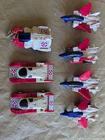 Group of transforming toy vehicles laid out showing overall composition