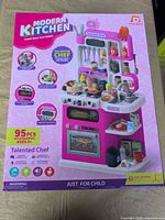 Front of sealed box showing pink Modern Kitchen playset and accessories
