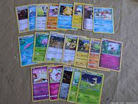 Overall view of roughly 21 assorted Pokémon cards laid out