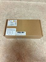 Closed brown box showing overall packaging