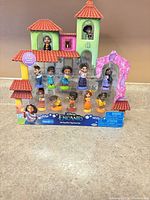 Front view of sealed Disney Encanto 12-piece figurine set in house-shaped package