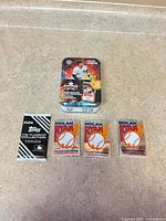 Group shot of sealed Aaron Judge tin, Topps 2026 pack, and three Nolan Ryan packs