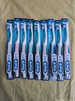 Front view of 10 sealed Oral-B CrossAction Compact soft toothbrushes