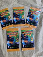 Five sealed Panini Haunted Hoops packs displayed front side