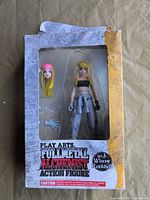 Front of sealed Play Arts Winry Rockbell figure showing figure, alternate head, hands, and box wear