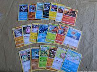 Array of Pokémon TCG cards spread on surface