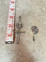 Large dirk-style kilt pin beside ruler and smaller stick pin