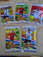 Front view of five sealed Star Card Collection Edition soccer trading card packs