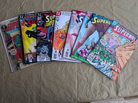 All seven Supergirl comics fanned out on tabletop