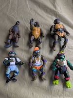 All six figures laid out on fabric