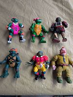 All six TMNT action figures laid out front view on cloth