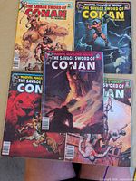 Five of the six magazine-sized comics spread out, showing varied cover art and the #79 issue in the centre