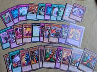 Overview of assorted Yu-Gi-Oh! cards spread out, showing mix of commons and holo rares