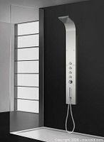 full view of stainless steel shower column installed, showing curved rainfall head and control panel