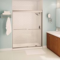 Stock photo showing installed MAAX Kameleon brushed nickel sliding shower door in bathroom setting