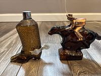 Front view of both amber glass bottles, boot and horse with rider