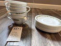 Stack of eight cups nested together beside stack of twelve saucers showing pattern and quantity