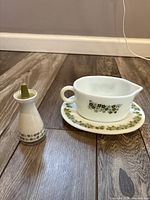 Gravy boat on underplate next to cruet