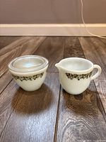 Creamer and lidded sugar bowl side by side