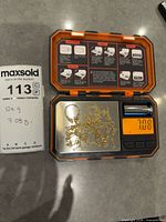 Chains and ring mount on digital scale reading 7.08 g