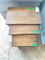 Top view showing three stacked tables and wood grain