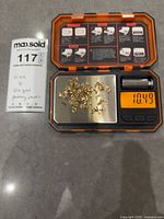 Pendant bails on digital scale reading 10.49 g