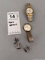 Overview of two wristwatches, pair cufflinks, tie tack