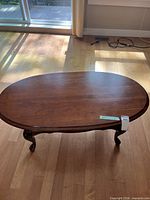 Full view of oval coffee table on hardwood floor