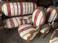 Settee and two of four armchairs showing overall style, upholstery pattern and carving