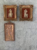overall view of three wall plaques showing styles and condition