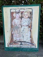 Front view of acrylic painting showing figures and text