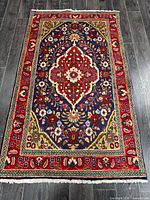 Full view of Persian Tabriz rug showing overall design and dimensions