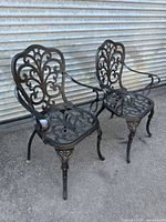Front view of both cast aluminum armchairs