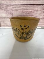 Front view of crock showing cobalt eagle motif and overall shape