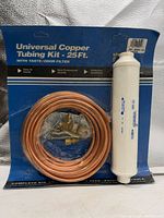 Front view of sealed Universal Copper Tubing Kit showing copper coil, filter, fittings