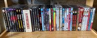 Shelf view of entire row of sealed DVDs and Blu-ray cases