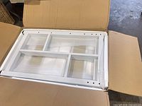 metal frame section inside cardboard box with foam