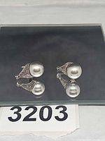 Front view of both earrings showing gray pearls and marcasite detailing