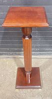 Full view of solid wood pedestal plant stand
