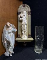All three items together: porcelain bride figurine, resin wall hanging, glass vase