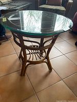 Full view of rattan side table with glass top