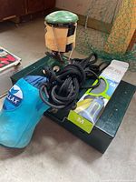 All four items grouped: stove, lantern, hammock bag with ropes, packaged dry bag