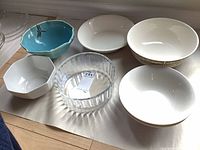 All seven bowls arranged on floor showing sizes and styles