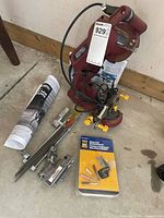 Sharpener unit with accessories laid out including manual and grinding wheel pack