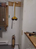 Overall view showing Troll panel handler, drywall T-square and nearby workshop setup