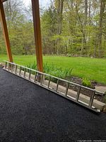 Full view of aluminum extension ladder on ground