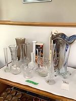 All vases on display including coloured art glass piece and boxed vase