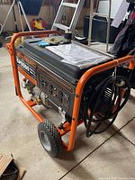 Left front view showing overall generator, frame, wheels, outlets and manual on top