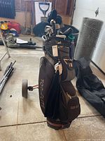 Overall view of Top-Flite bag with clubs and push cart