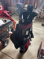 Golf bag filled with clubs and headcovers visible